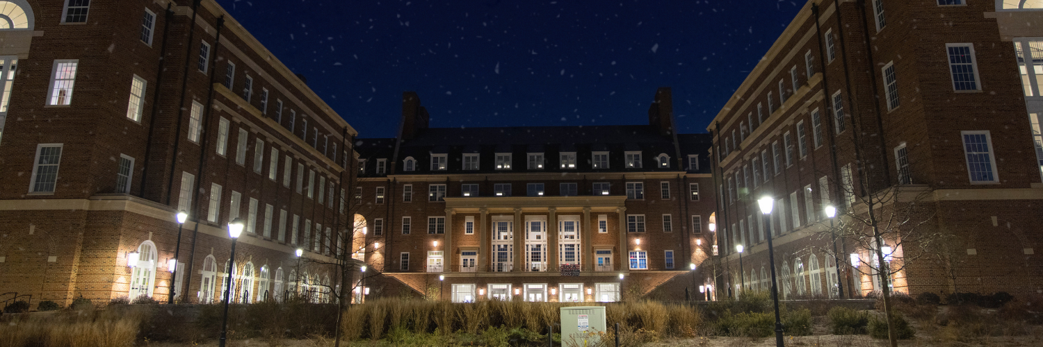 Photo of UGA's Business Learning Center, lit up at night