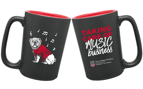 Front and back of a mug (black exterior, red interior); one side shows an illustrated jersey-wearing bulldog surrounded by musical notes and the other reads 'Taking Care of Music Business' in addition to the Terry College of Business Music Business Program logo