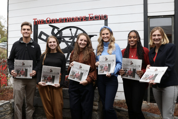 Community Journalism - Students holding copies of The Oglethorpe Echo newspaper